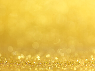 Gold Festive Christmas background. Abstract twinkled bright background with bokeh defocused golden...