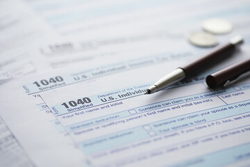 Annual tax reporting. Tax form on the table. Financial statements for signature.