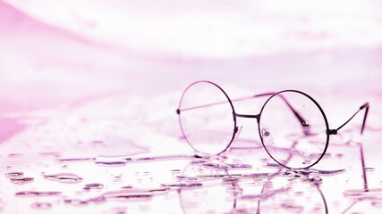 Tools for vision correction. Glasses and lenses with diopters on the background of splashes and blurry.