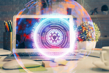 Computer on desktop in office with technology theme hologram. Double exposure. Tech concept.