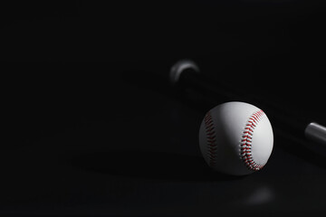 American traditional sports game. Baseball. Concept. Baseball ball and bats on a black table.