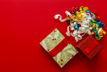Christmas background with gift boxes and decorations on red.