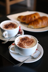 Cup of coffee and croissant