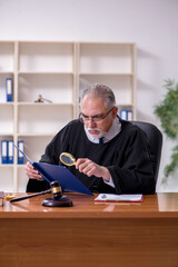Fototapeta premium Old male judge working in courthouse
