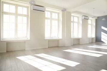 Empty light white room with window with sunlight.