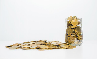 money wealth savings concept. coins pile and coins growth in container to collect increase growth...