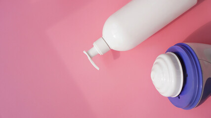 Lotion and anti-cellulite massager on a pink background. Healthy and beautiful skin concept.