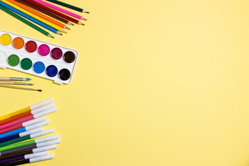 Fototapeta premium Stationery for children's drawing on yellow background. Children's creativity concept. Copy space.