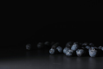 Water drops on ripe sweet blueberry. Fresh blueberries background with copy space for your text. Vegan and vegetarian concept. Macro texture of blueberry berries.
