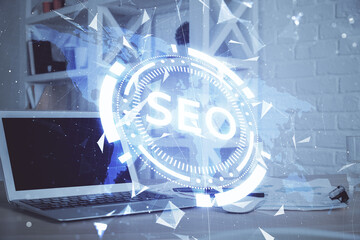 Multi exposure of table with computer and seo drawing hologram. Search optimization concept.