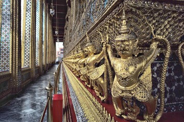 Closeup golden Garuda birds decorated on the wall of Buddhism temple in Thailand. Attractive place for tourism