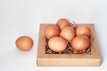Chicken brown eggs on a white table