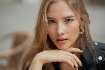 portrait of a young mysterious woman of Caucasian appearance ethnic. Mysterious smile, open eyes and sunlight on the face.Waiting for a young man