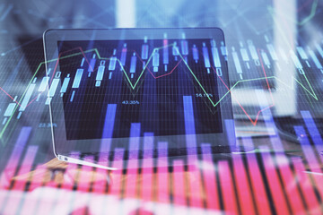 Forex Chart hologram on table with computer background. Multi exposure. Concept of financial markets.