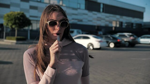 Close up pretty young hipster woman. Happy brunette vaper girl with e-cig. Portrait of smoker female model with electronic cigarette