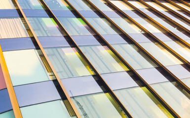 Closeup of glass wall of modern building. Colorful glass texture