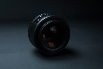 Camera lens close up on black background.