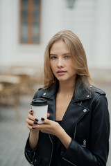 a beautiful modern woman of Caucasian appearance, fragrant delicious hot coffee Cup in her hands. thinking about the working days