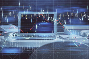 Double exposure of chart and financial info and work space with computer background. Concept of...