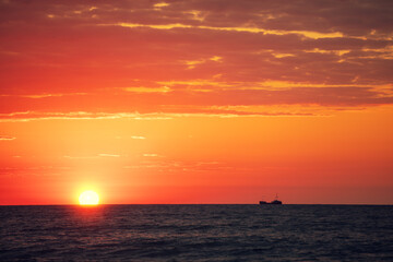 Naklejka na ściany i meble Early morning. Red sunrise over the sea