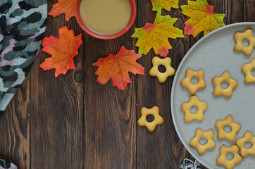 cozy home atmosphere warming cocoa drink in cold weather, warm stole and maple autumn leaves, cold prevention and thanksgiving day concept