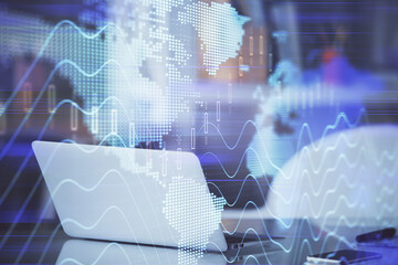 Stock market graph on background with desk and personal computer. Double exposure. Concept of financial analysis.