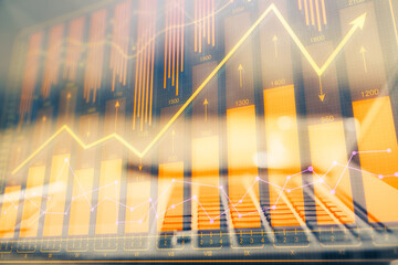 Financial graph colorful drawing and table with computer on background. Double exposure. Concept of international markets.