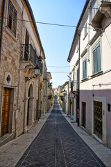 Fototapeta na wymiar A narrow street among the old houses of San Bartolomeo in Galdo, a small town in the province of Benevento, Italy. 