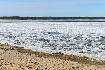 Ice drift on a wide river on a Sunny spring day