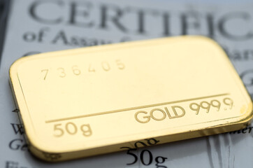 Minted gold bar weighing 50 grams 999.9, fineness with certificate. Gold ingot with assay...