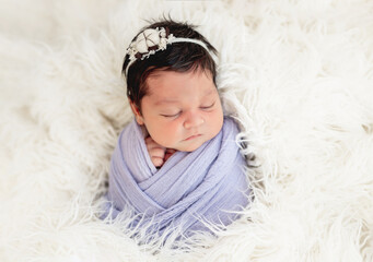 Smiling newborn in knitted hat