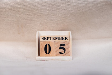 September 5th. Image of September 5 wooden color calendar on white canvas background. empty space for text