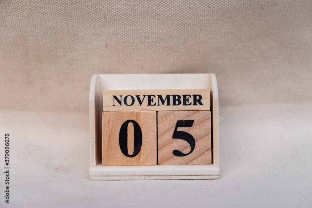 Fototapete november 5th. image of november 5 wooden color calendar on white canvas background. empty space for 