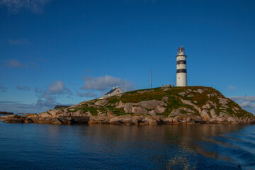 Fototapeta na wymiar Halten lighthouse is a lighthouse located in the fishing village Halten in Frøya municipality in Trøndelag. The lighthouse was established on Halten in 1875. The lighthouse is a 29.5 m high