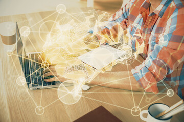 Man typing on keyboard background with brain hologram. Concept of big Data.