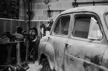 Barcelona, Spain; August 6, 2018: Very old car in the old mechanical workshop. Standard Motor...
