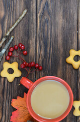 Autumn background warming cocoa drink and autumn leaves on wooden background with copy space for text or design