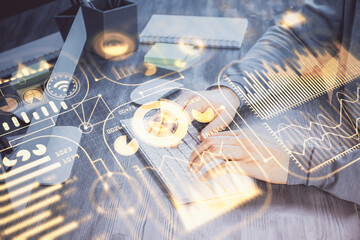 Technology theme hologram with man working on computer on background. High tech concept. Double exposure.