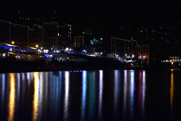 Fototapeta na wymiar City of Camogli seen at night, with all its wonderful lights reflected in the sea