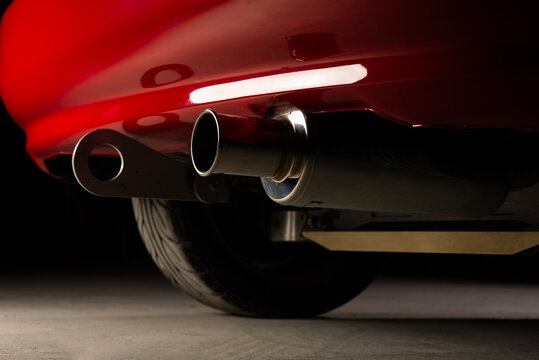 Car detailing series: Closeup of red car exhaust pipe