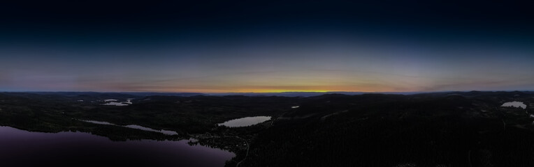 Panorama view over forest wilderness in Scandinavia at sunset.