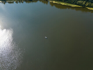 Aerial drone top view. Rubber motor boat on the river.