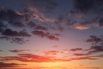 Fototapeta na wymiar Beautiful sunrise, sunset orange yellow pink blue sky with clouds and sunlight background texture