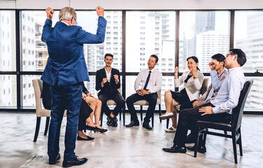 Businessman standing in front of group of people in consulting meeting conference seminar at hall or seminar room.presentation and coaching concept