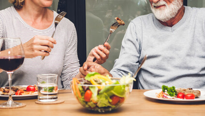 Senior couple enjoy eating healthy breakfast together in the kitchen.Retirement couple concept