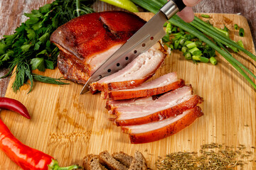 smoked meat lies on the table with herbs and sauce