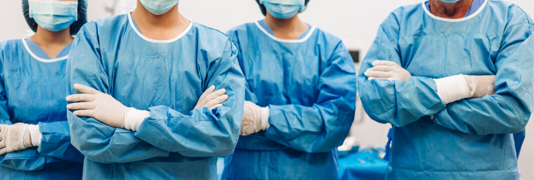 Portrait of professional anesthesiologist doctor medical team and assistant standing with surgery equipment in modern hospital operation emergency room