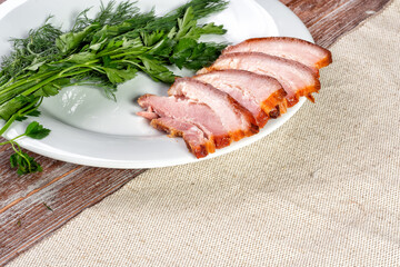 smoked meat lies on the table with herbs and sauce