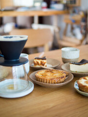 Set of sweet bakery in dishes ,Cone dripper on glass pot and ceramic cup.