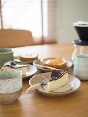 Selective focus at first dish of cake, collection of sweet bakery on wood table in cafe.
